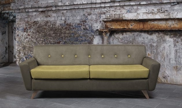 olive green sofa with contrasting cushions in industrial settingatrium of large office building with seating