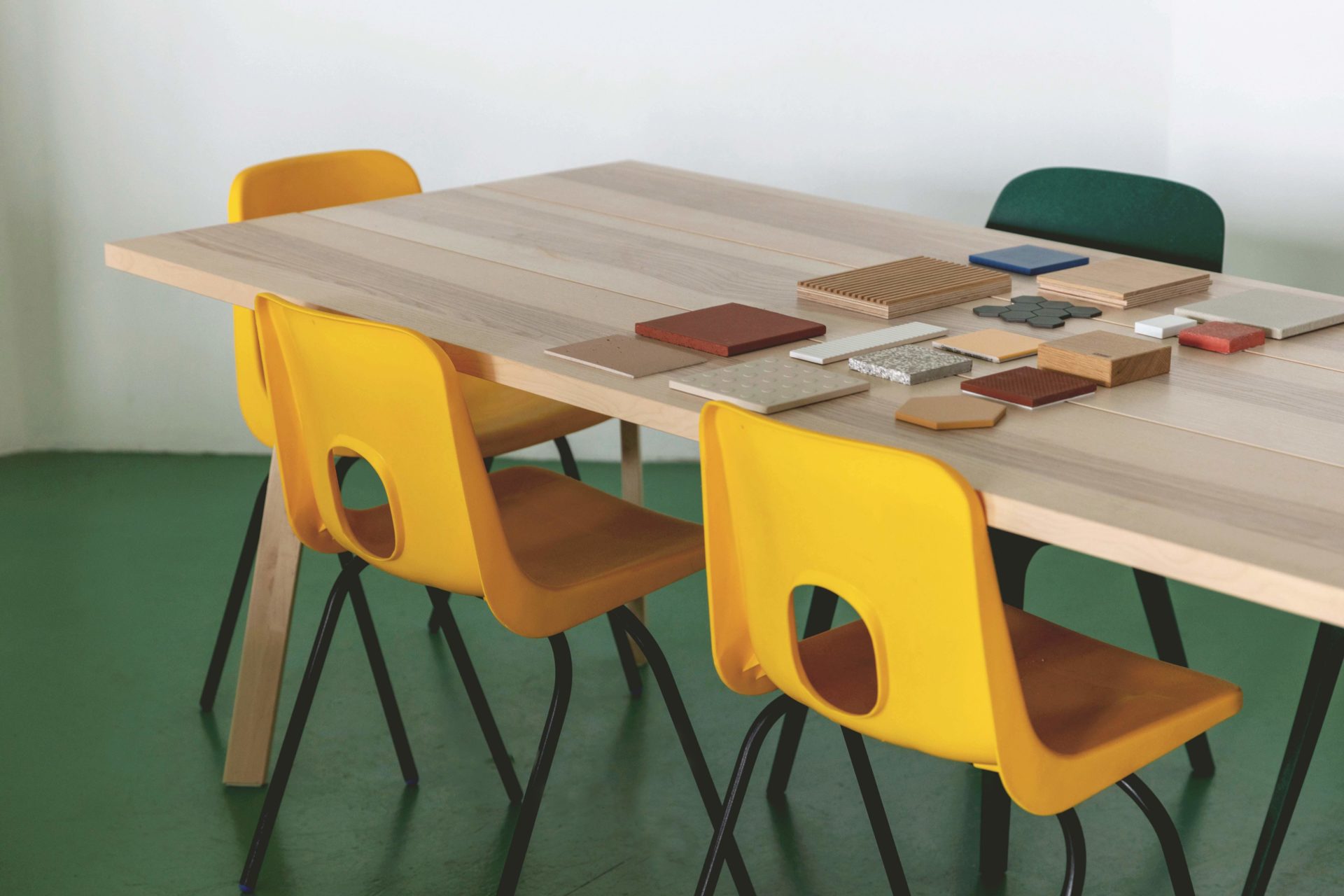 Emil Eve Architects Studio wooden meeting table with yellow chairs