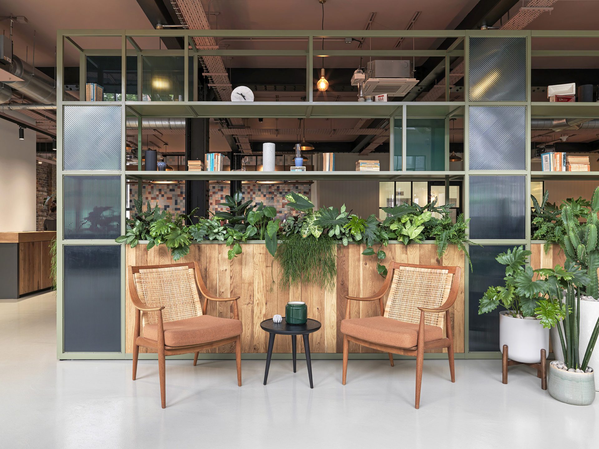 Rattan backed chairs in front of shelving unit