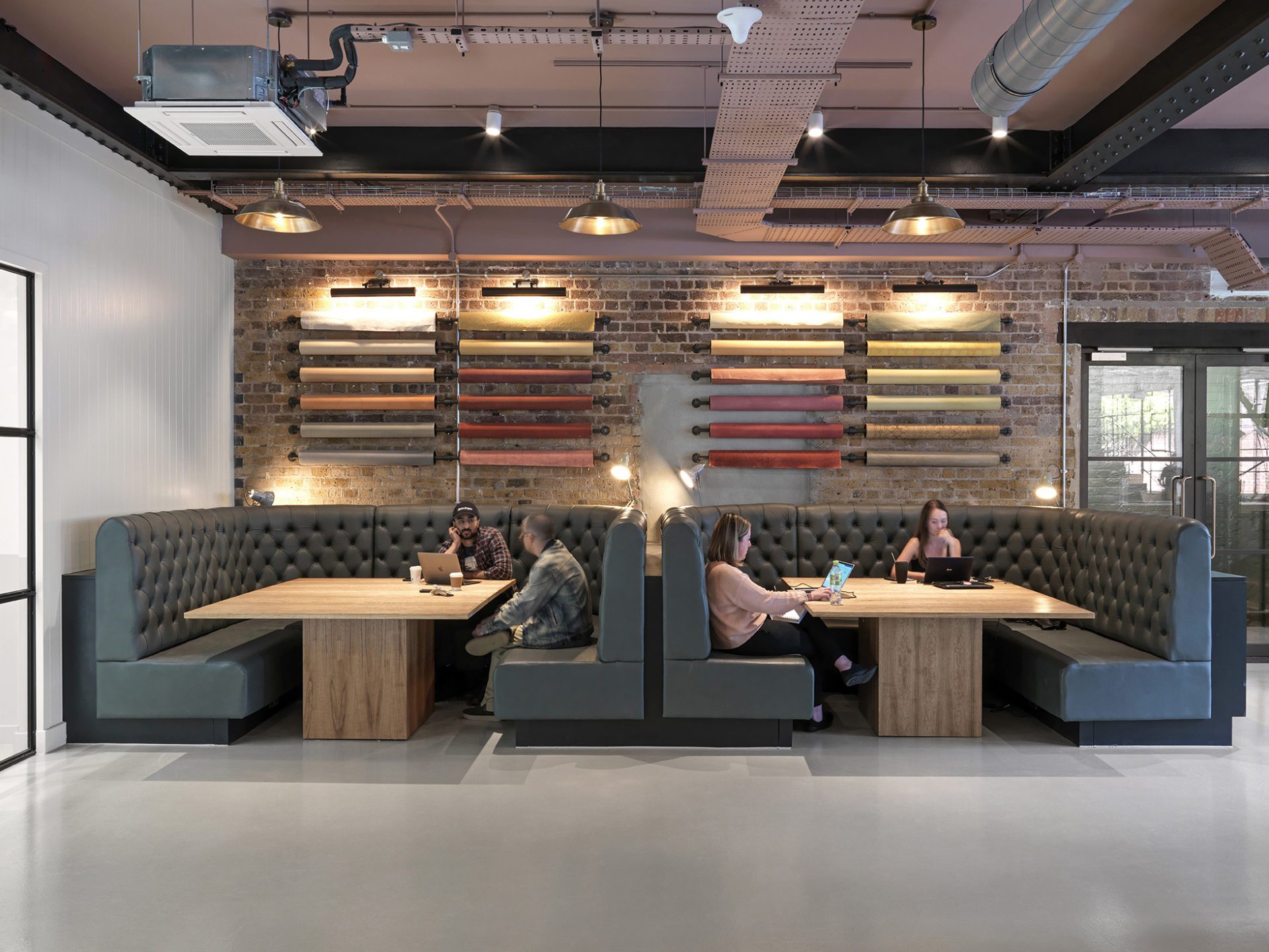 Banquette seating with a feature roles of wallpaper on the wall behind