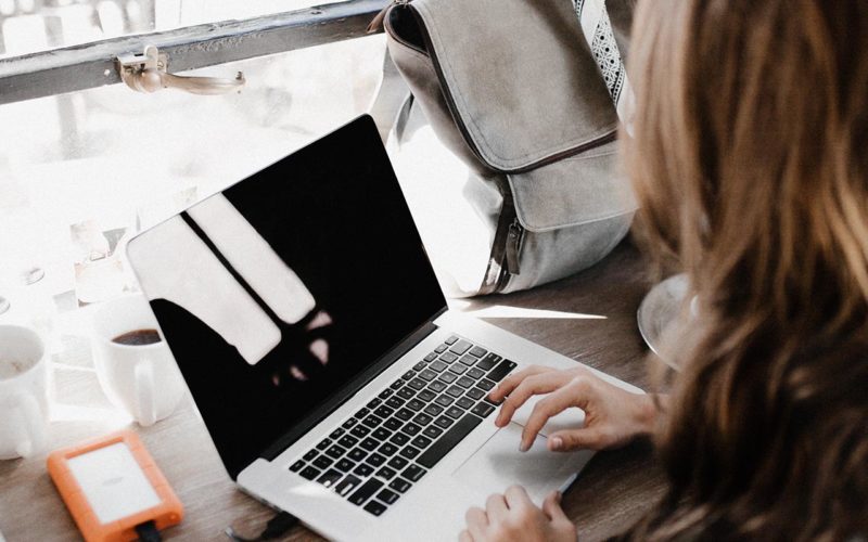 Woman working in cafe on laptop